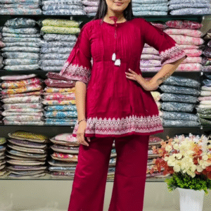 Women’s Red Embroidered Kurti Pant Set – White Threadwork Details with Boutique Shelf Backdrop